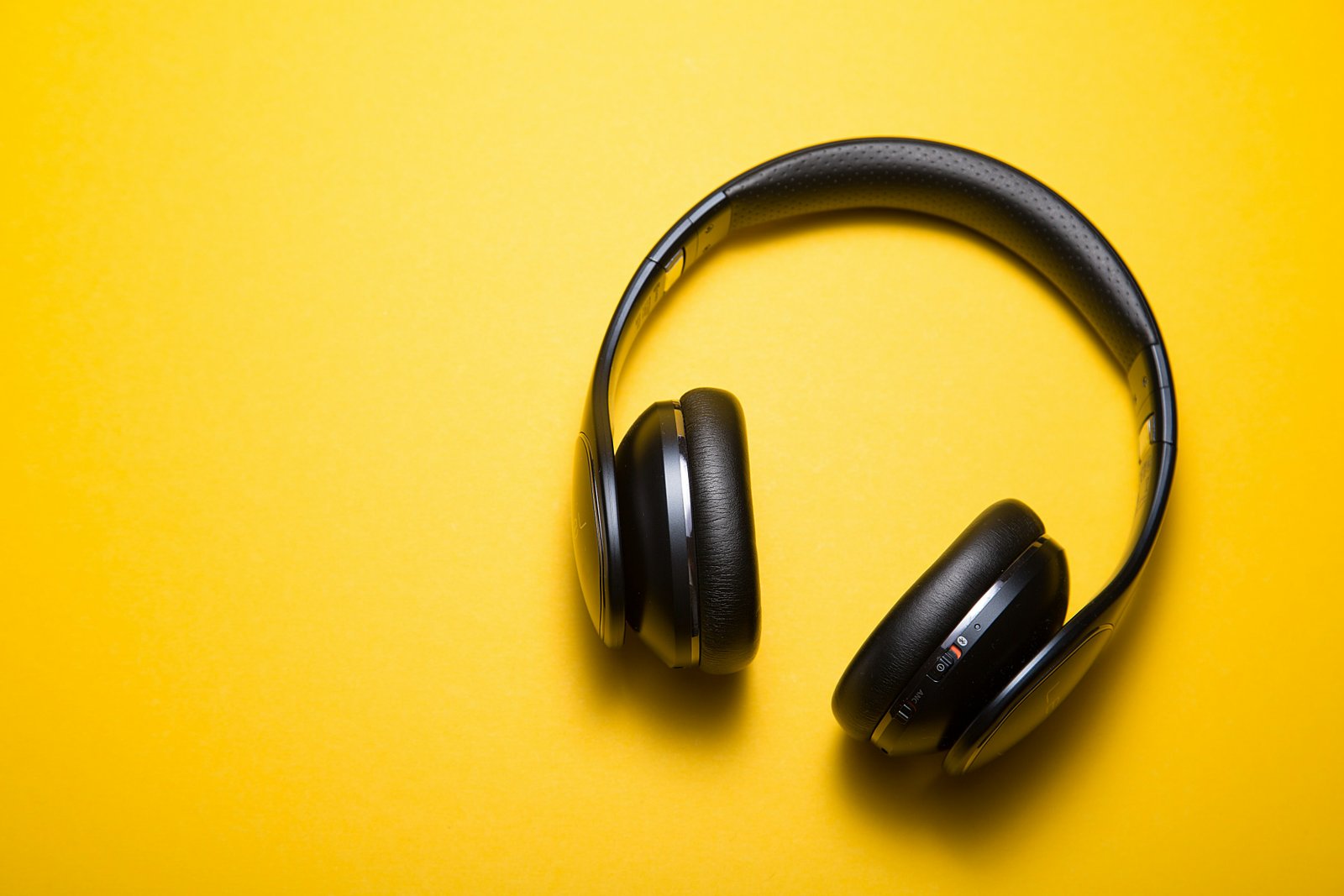 Headphones photographed on a yellow background